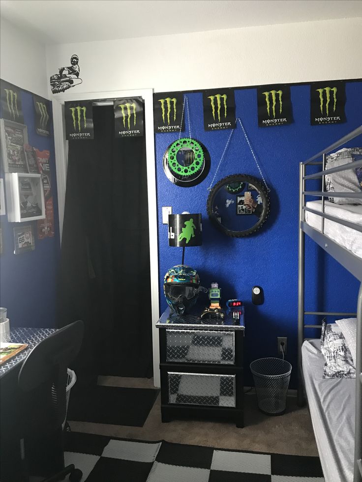 a bedroom with blue walls and black and white checkered flooring, monster flags on the wall