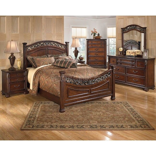 a bedroom scene with focus on the bed and dresser