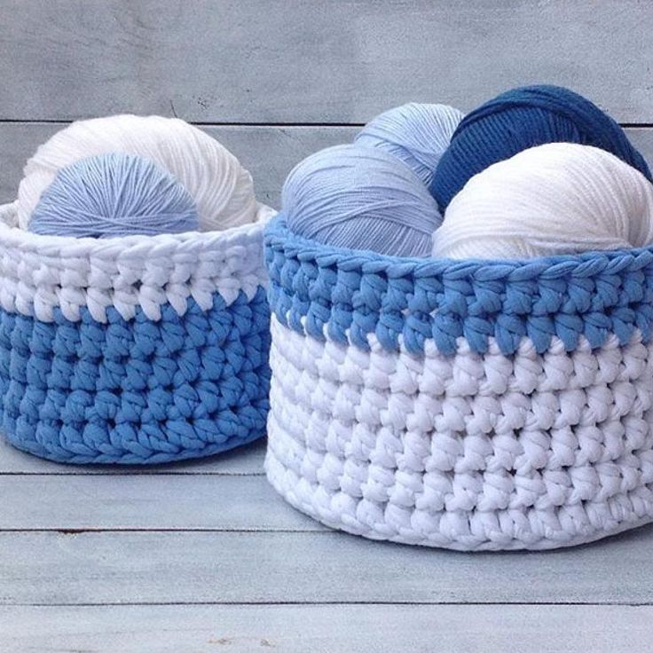 two crocheted baskets with balls of yarn in them