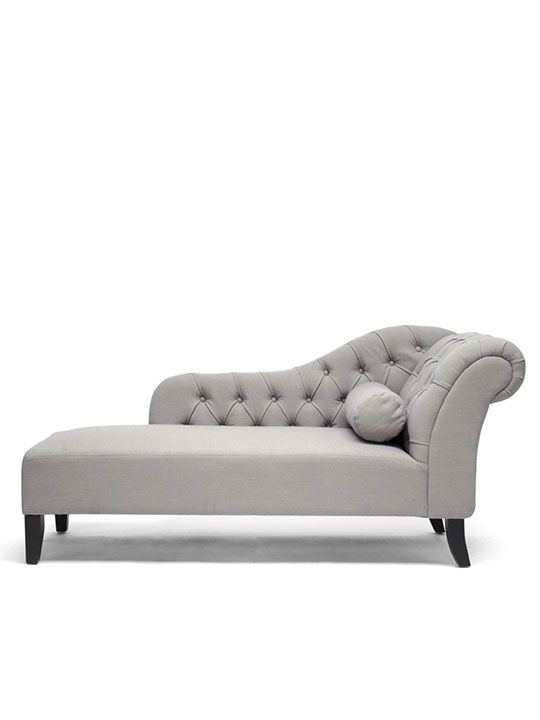 a gray chaise lounger sitting on top of a white floor