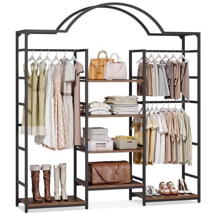 an open closet with clothes and handbags on the shelves next to shoes, bags and purses