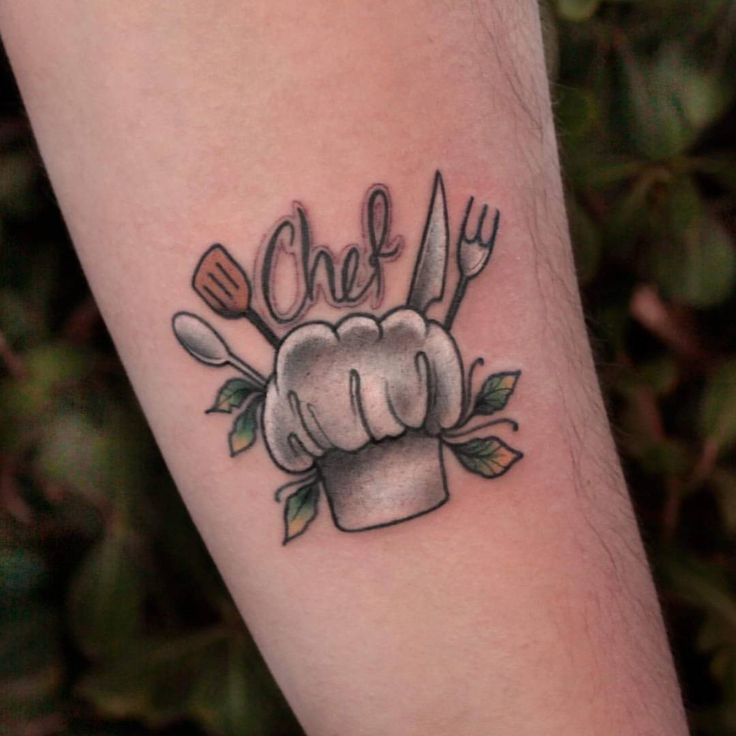 a chef's hat tattoo with utensils and leaves on the arm that says chef