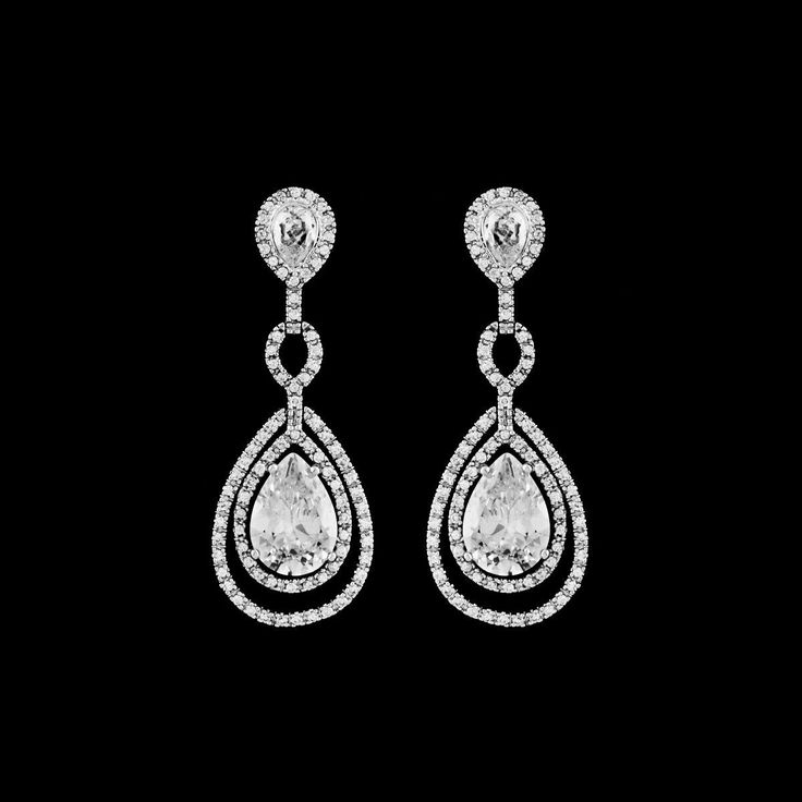 Hollywood glam bold dazzling and sophisticated CZ wedding bridal Earrings.the perfect drop earring for the bride that loves tradition but just needs to all a little more bling.Absolutely gorgeous 2 1/4" long drop High End Cubic Zirconia wedding earrings. ---------------------------------------------------------------add our beautiful crystal bracelet (sold separately) measures approx 6 3/4- 7" long small to standard fit + extender if needed *Note processing time is not shipping time, our regular Classic Diamond Linear Earrings For Wedding, Wedding Long Drop Linear Earrings In Cubic Zirconia, Diamond Linear Long Drop Earrings For Wedding, Diamond Long Drop Linear Earrings For Wedding, Classic Cubic Zirconia Linear Earrings For Wedding, Dazzling Cubic Zirconia Linear Earrings For Wedding, Diamond White Drop Diamond Earrings For Wedding, Elegant Linear Earrings With Sparkling Stones For Wedding, Pear-shaped Diamond Chandelier Earrings For Wedding