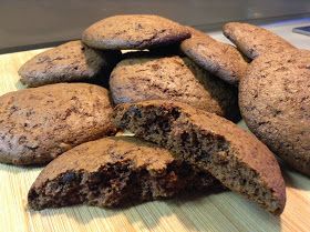 a pile of cookies sitting on top of a wooden cutting board