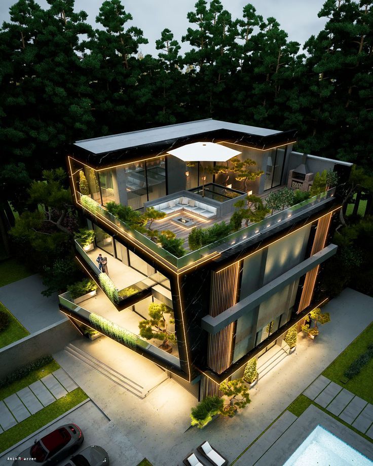 an aerial view of a modern house in the middle of trees and lawns at night