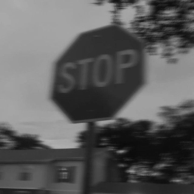 a black and white photo of a stop sign