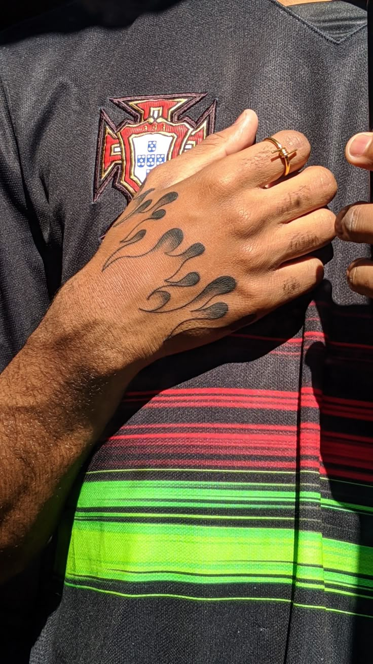 a man with tattoos on his arm and hand