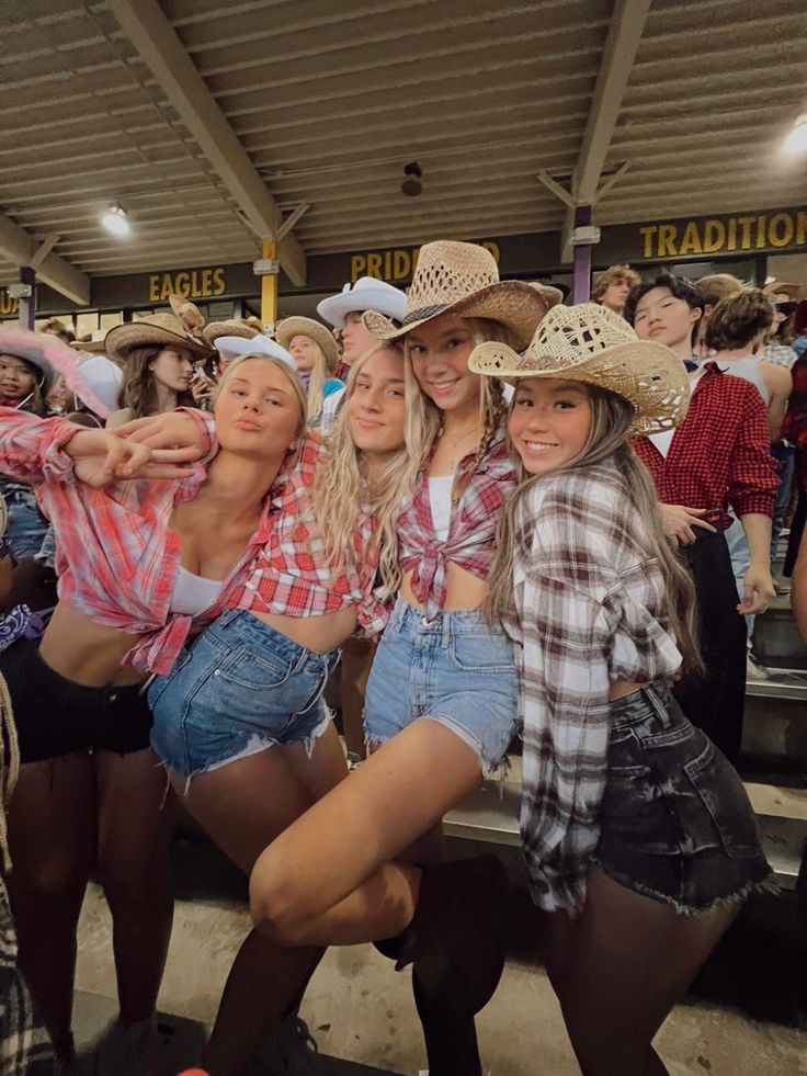 several girls in cowboy hats posing for the camera