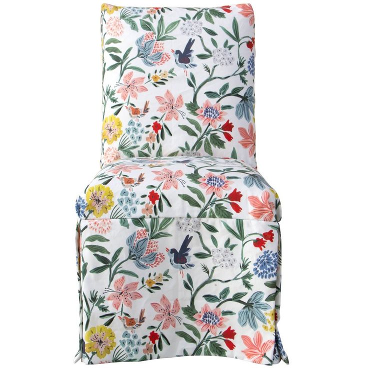 a white chair with colorful flowers and birds on the seat cover, in front of a white background