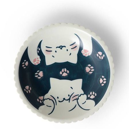 a black and white plate with an image of a cat on it's back