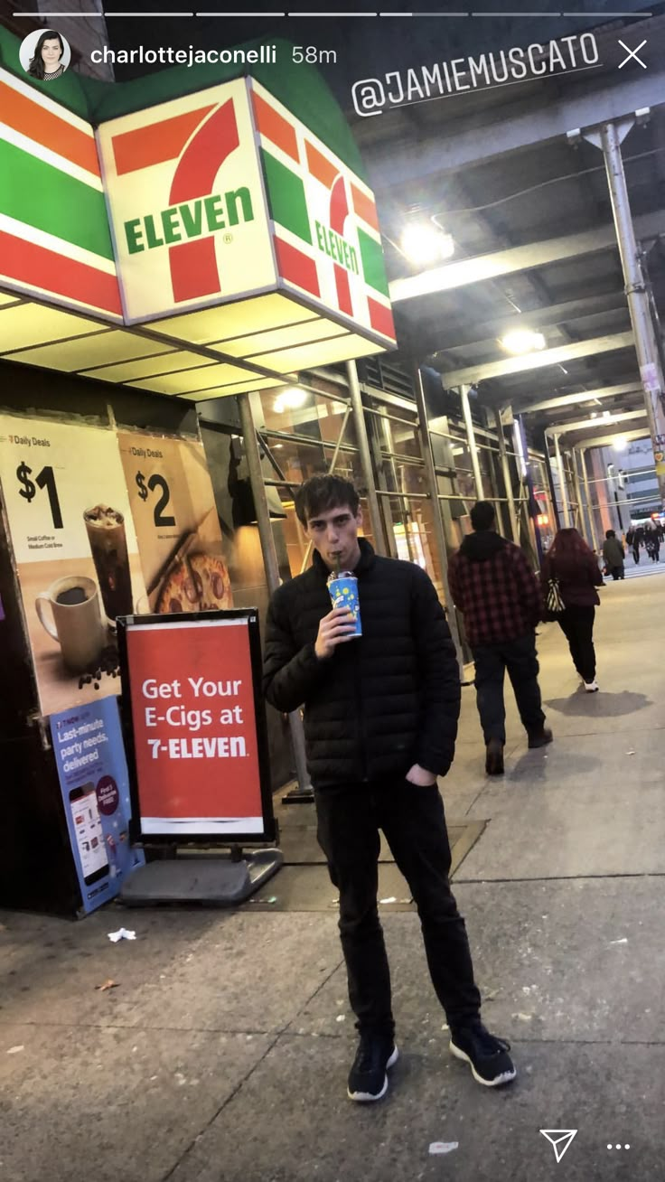 a man standing in front of a store holding a cell phone