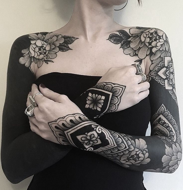 a woman with tattoos on her arm and arms