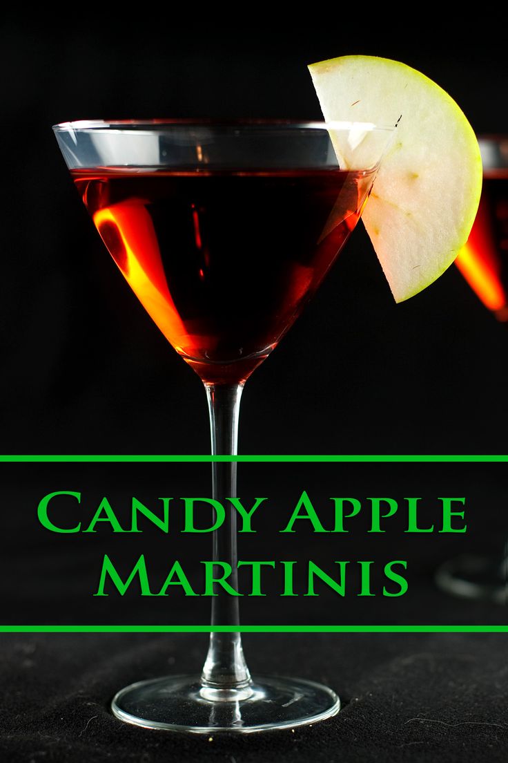 two glasses filled with liquid sitting on top of a table next to an apple and the words candy apple martinis