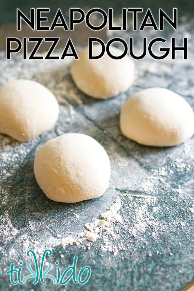 three small pizza dough balls sitting on top of a pan