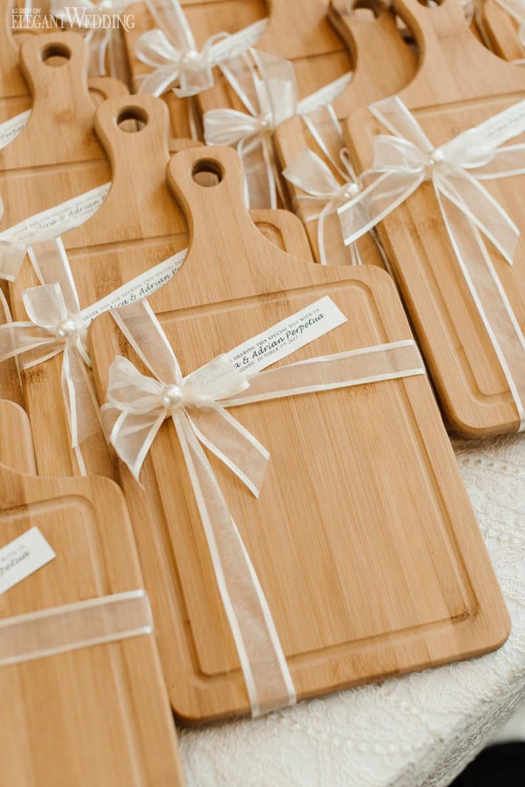 several wooden cutting boards tied with white ribbon