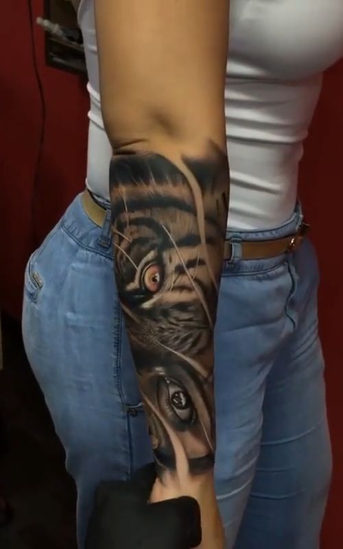 a woman with a tiger tattoo on her arm