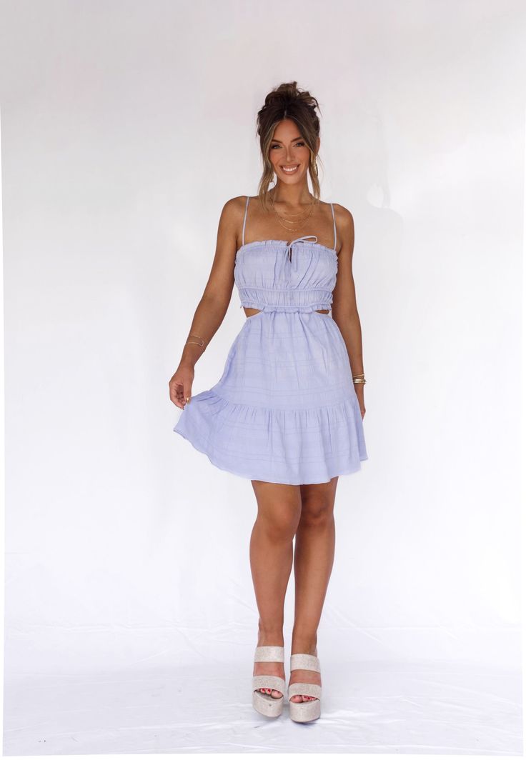 The Windswept Wishes Dress features a flattering cutout waist and playful ruffles, perfect for a summer or late summer look. With a charming tie detail in the front, this mini dress combines style and functionality for a chic and comfortable outfit. Fabric 97% polyester, 3% spandex Lining 100% polyester Mini Dress With Tie Straps For Day Out, Mini Dress With Tie Straps For Brunch, Summer Mini Dress With Tie Straps, Flirty Mini Hem Dress For Day Out, Flirty Mini Beach Dress, Feminine Mini Sundress With Tie Back, Flirty Mini Dress For The Beach, Flirty Mini Dress With Mini Hem For Day Out, Mini Sundress With Tie Back For Date Night