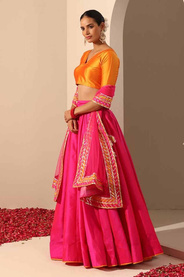 Hot pink solid lehenga crafted in tafetta silk with statement tassels. Paired with a blouse and gota lace bordered dupatta.
Components: 3
Pattern: Embroidered
Type Of Work: Gota lace
Neckline: V Neck
Sleeve Type: Elbow
Fabric: Lehenga and Blouse: Tafetta Silk, Dupatta: Soft Net
Color: Pink
Other Details: 
Length:
Lehenga: 40 inches
Dupatta: 2.5 mtrs
Dupatta width: 44 inches
Occasion: Mehendi and Haldi - Aza Fashions Festive Silk Dupatta With Tassels, Bollywood Choli With Tassels, Traditional Pink Sets With Tassels, Traditional Pink Tassel Sets, Festive Fitted Choli With Tassels, Festive Choli With Tassels, Pink Tassel Sets For Navratri, Festival Choli With Latkans, Traditional Fitted Sets With Tassels