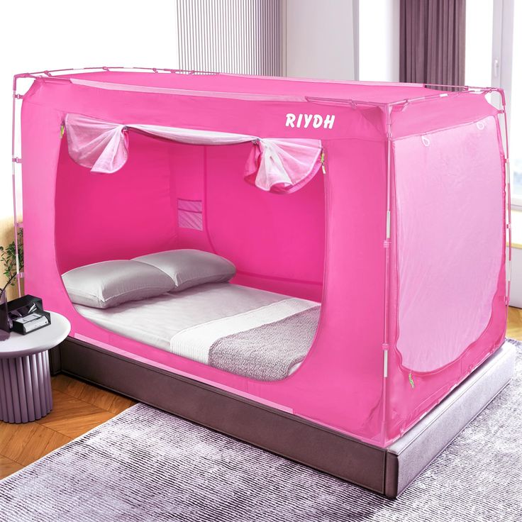 a bed with a pink tent on top of it