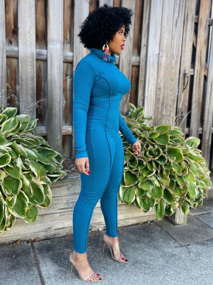 Turn heads in this cutout body hugging turtleneck jumpsuit. Details: Stretch Jumpsuit Turtleneck Cutout No closure Ribbed 64% polyester; 33% rayon; 3% spandex Dry Clean Only Inseam is 32 inches Model is wearing size Medium Model Measurements: Size: Medium (8/9) • Height: 5'6 • Bust: 34 • Waist: 29 • Hips: 41.5 • Fitted Blue Elastane Unitard, Blue Fitted Elastane Unitard, High Neck Unitard With Thumbholes, High Stretch High Neck Solid Color Unitard, High Stretch High Neck Solid Unitard, High Neck Solid Color High Stretch Unitard, Stretch Solid Color Jumpsuits And Rompers For Fall, Long Sleeve Tight Unitard With Thumbholes, Blue Stretch Jumpsuits And Rompers For Winter