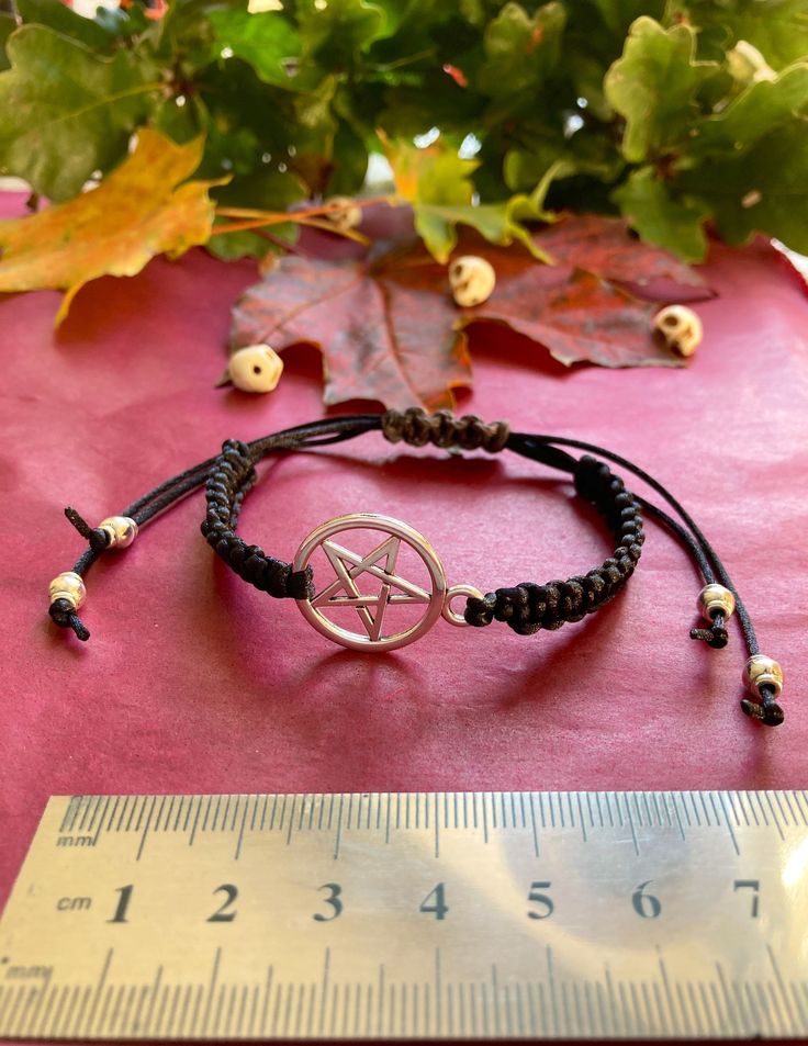 Pentagram Bracelet. Great Fun Halloween Witch Fancy Dress Costume Jewellery. Beads Tibetan Silver. Shamballa Style braided Bracelet. Black Braid Satin Cord. Grey Hemp Slip Knot. Size Fits small and large wrist (see ruler in pictures). Approx 6cm to 14cm (range). Gothic Adjustable Bracelets For Halloween, Handmade Adjustable Gothic Bracelet, Handmade Adjustable Gothic Bracelets, Handmade Halloween Festival Bracelets, Handmade Halloween Festival Bracelet, Gothic Adjustable Beaded Bracelets For Halloween, Adjustable Gothic Beaded Bracelets For Halloween, Bohemian Handmade Bracelets For Halloween, Handmade Bohemian Bracelets For Halloween