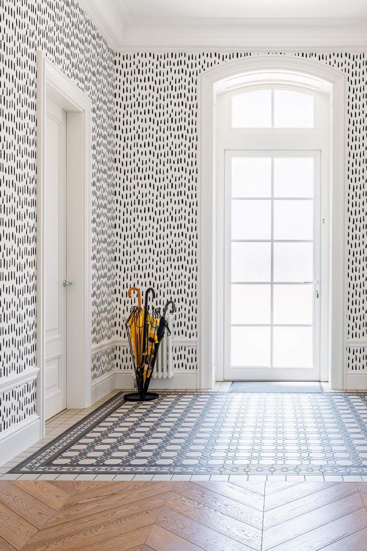 an empty room with two vases on the floor