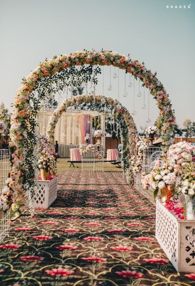 an outdoor ceremony with flowers and greenery