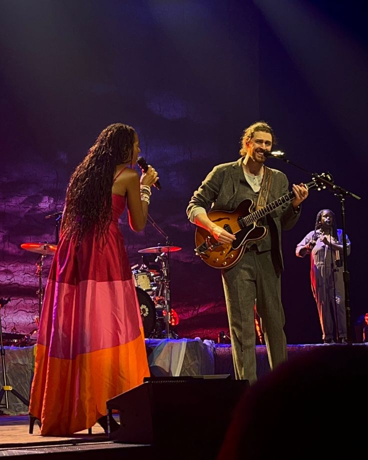 a man and woman on stage playing instruments