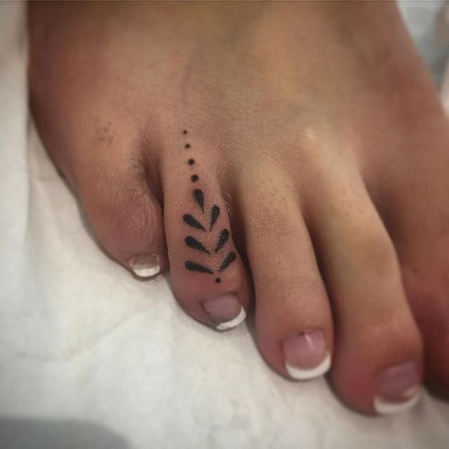 a person has a small tattoo on their foot