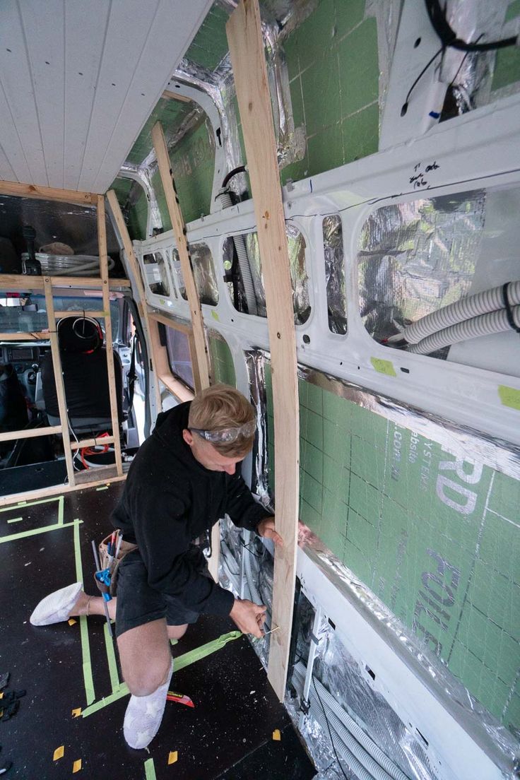 a man working on the inside of a bus