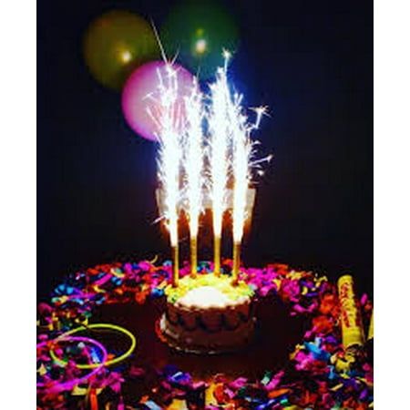 a birthday cake with lit candles and balloons