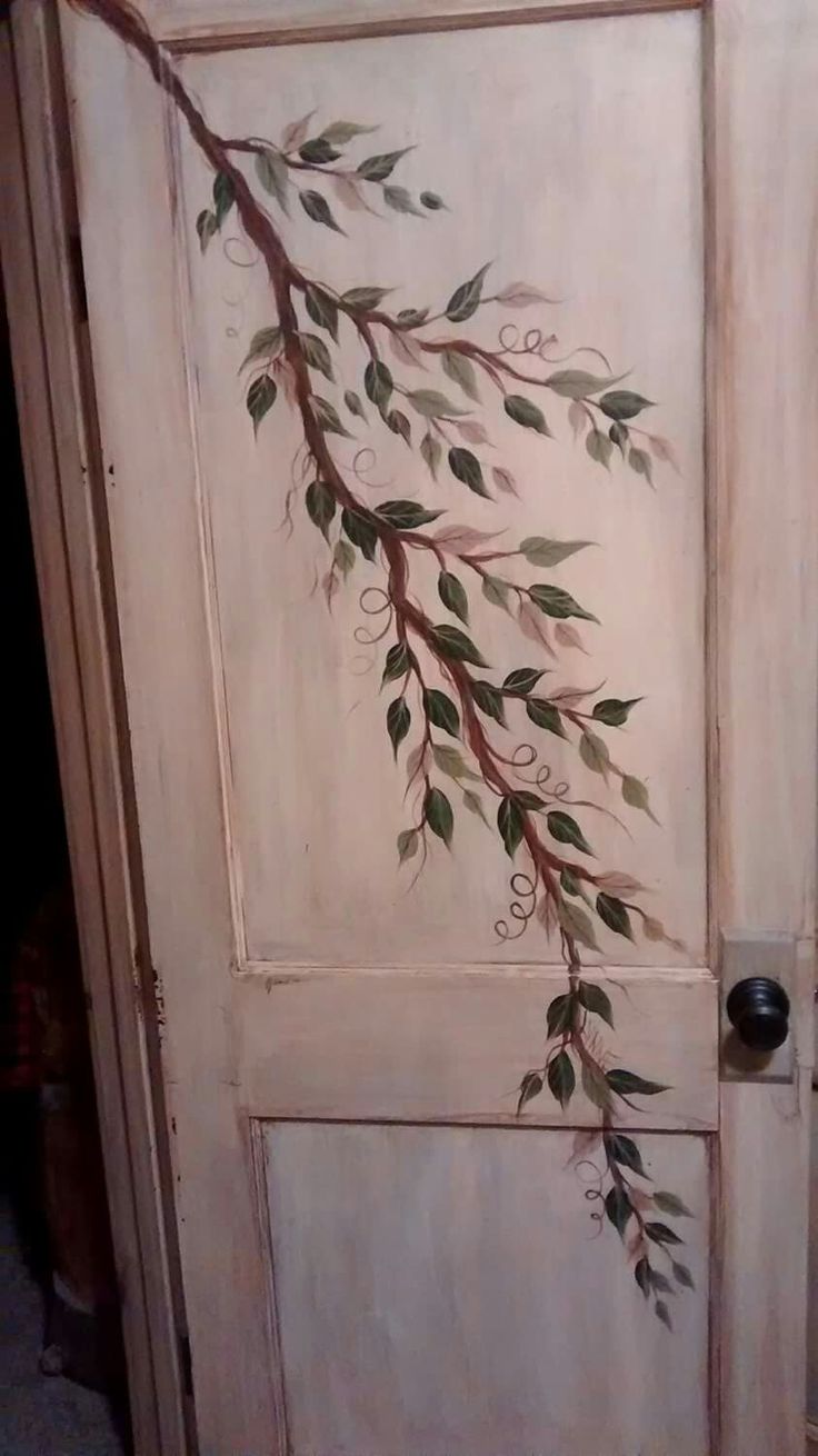 the door is painted with leaves and vines