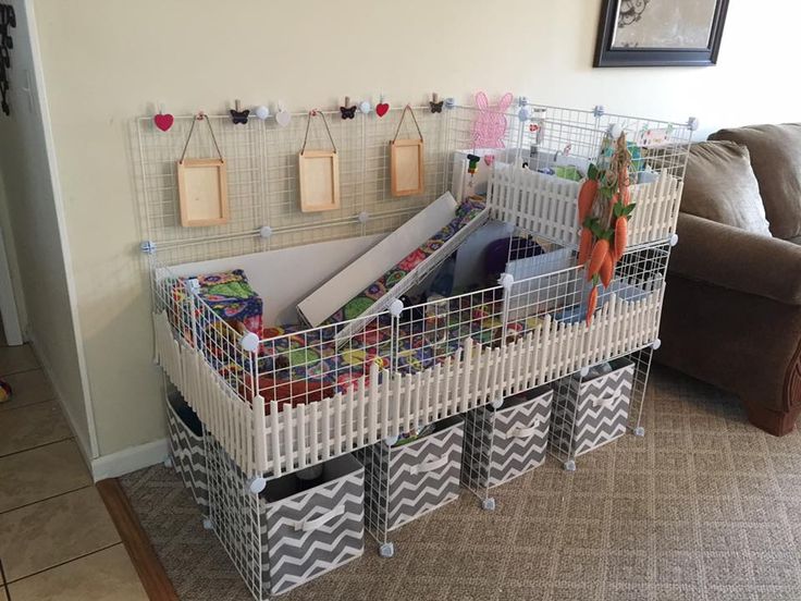 a living room filled with lots of toys and decor on the wall next to a couch