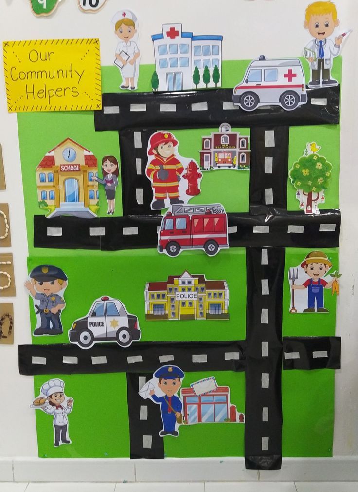 a bulletin board is decorated with pictures of people and vehicles on the side of it