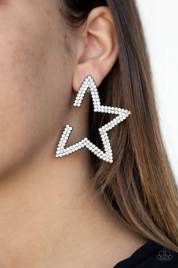 Encrusted in two rows of smoky hematite rhinestones, a gunmetal star frame dots the ear for a stellar shimmer. To flatter the natural contour of the face, one side angle of the star frame is intentionally left open. Earring attaches to a standard post fitting. Side Angle, Natural Contour, Crystal Stars, Paparazzi Accessories, White Rhinestone, Black Earrings, Paparazzi Jewelry, Affordable Jewelry, Black Star