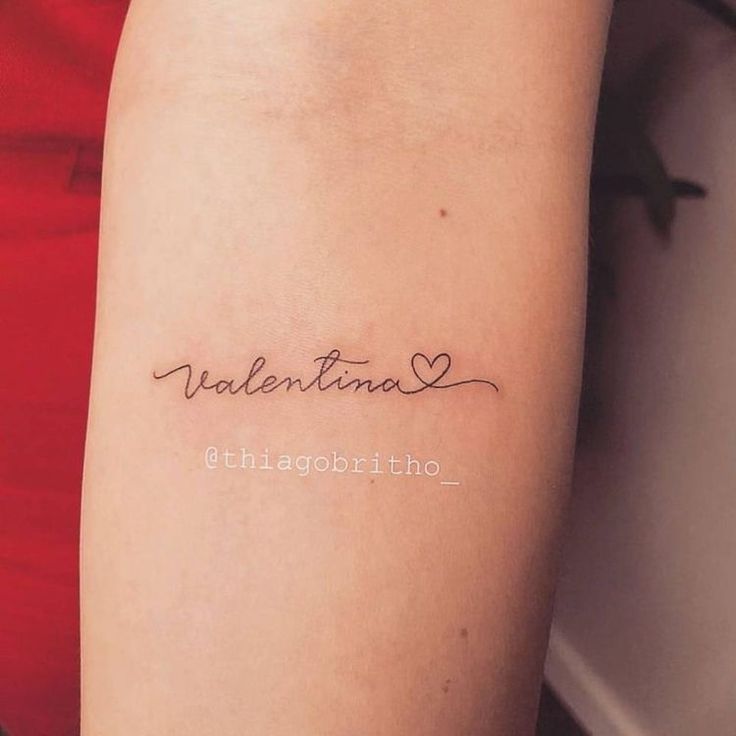 a woman with a tattoo on her arm that reads valentinea ethagortho