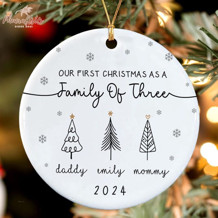 a christmas ornament hanging from a tree with the words, our first christmas as a family of three today only mommy