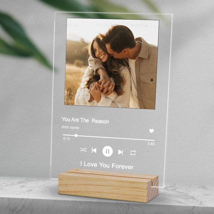 a clear acrylic photo frame with an image of a couple holding each other