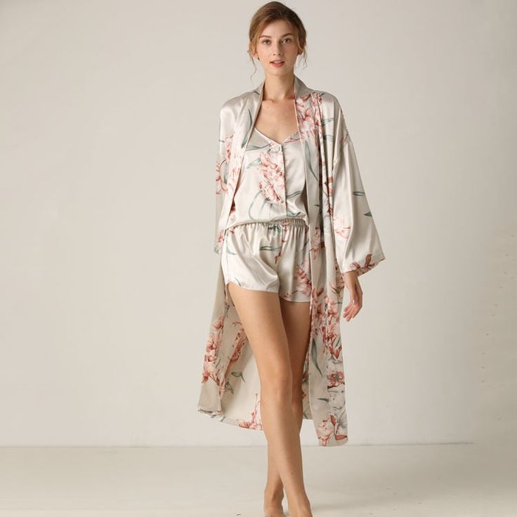 This Silky Satin 3 Piece Women Sleepwear Suit Cozy and Comfortable from Original Pajamas is a luxurious 3-piece satin pajama set, which is perfect for lounging around the house or for going to bed. Made with high-quality fabric, this soft and cozy set includes a top, matching shorts, and a matching robe. This loungewear is all you need to help relax at home. They are soft and easy to touch which projects versatility and effortless grace in every step you take. Made to make you feel good, each of Lingerie Satin, Kimono Gown, Satin Nightwear, Floral Pajama Set, Bridal Party Gowns, Pyjama Satin, Kimono Floral, Bath Robes For Women, Satin Sleepwear