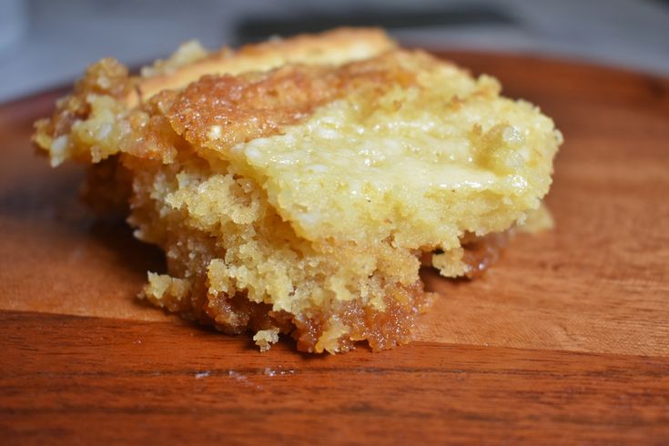 a piece of cake sitting on top of a wooden cutting board