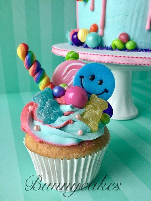 there is a cupcake decorated with candy and candies