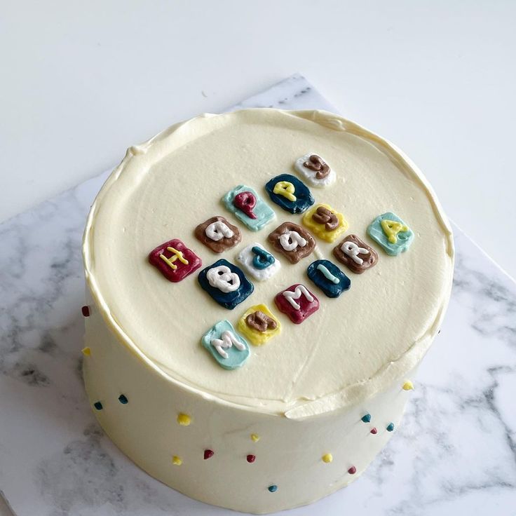 a white cake topped with lots of colorful candies