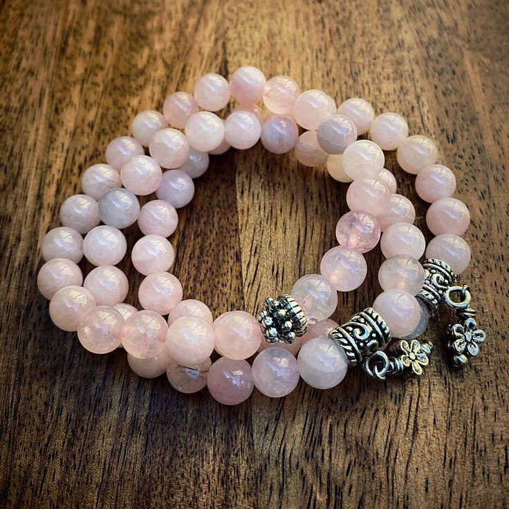 Three strands of pink stones with metallic pendants. Pink stones are a combination of pink mountain jade, rose quartz, and smokey rose quartz. (See more in “About Our Stones”.) Pink Mountains, Yoga Mala, Pink Stones, Mala Bracelet, Pink Stone, Metal Pendant, Gemstone Bracelets, Bracelet Stack, Yoga Mats