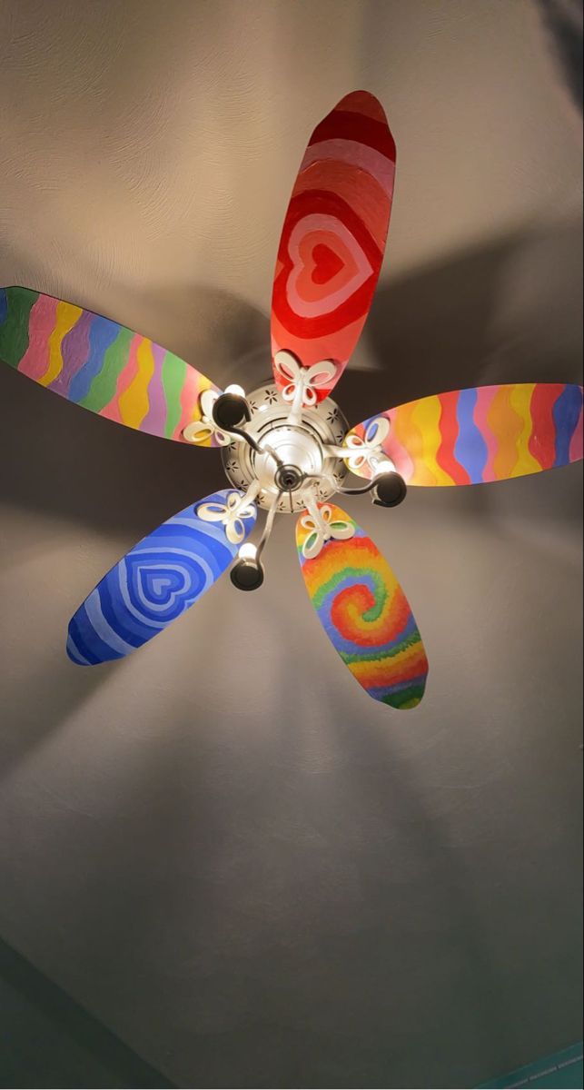 a multicolored ceiling fan hanging from the ceiling