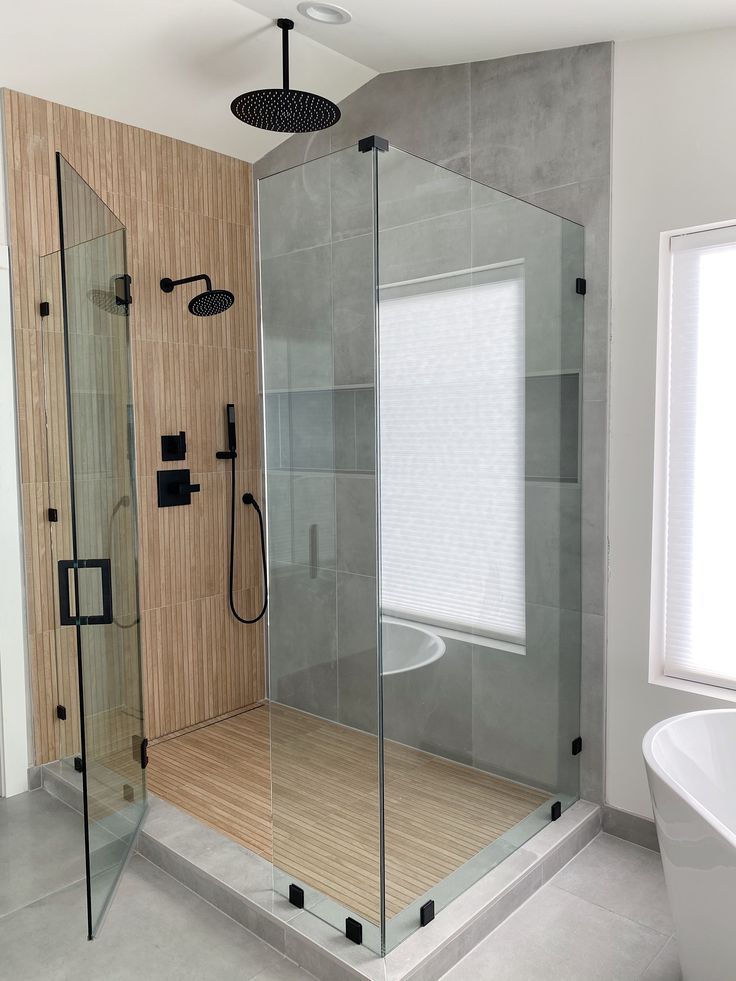 a bathroom with a walk in shower next to a bathtub