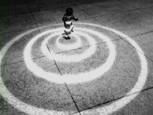 a black and white photo of a fire hydrant in the middle of a circle