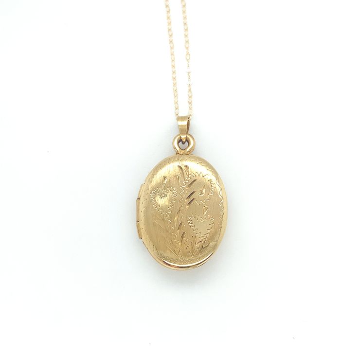 All of our jewelry is guaranteed authentic by our Graduate Gemologist of the Gemological Institute of America (GIA). 14k Yellow Gold Oval Locket with Hearts and Engraved Design (#J6437) 14k yellow gold oval shaped locket on chain. The locket measures just over 1" long with bail by 5/8" wide and has pretty engraved design with two hearts. The pendant includes a new 20" 14k yellow gold chain. The necklace weighs 2.46 dwt., and is contemporary. Pretty! SKU#J6437. 100% Satisfaction Guaranteed! Victorian Jewelry In 14k Gold With Hallmark, Victorian 14k Gold Jewelry With Hallmark, Heirloom 14k Gold Oval Link Jewelry, 14k Gold Oval Link Locket Jewelry, Heirloom Yellow Gold Necklace With Hallmarks, Gold Engraved Oval Cabochon Necklace, Oval 14k Gold Jewelry, Heirloom 14k Gold Jewelry With Oval Link, Heirloom Oval Link Jewelry For Wedding