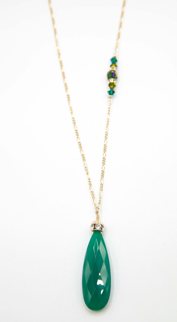 A large Emerald green Adventurine Crystal is adorned with a Swarovski Rhinestone rondelle and cap. 34”in length this amazing necklace is everyday wear or perfect for a dressy occasion. Dangles with easy movement from 14k gold fill or sterling silver. Extremely high quality chain and clasp with all closed jump rings. Side detail makes the necklace absolutely amazing, green Swarovski crystals. Available in Sterling silver or 14K gold fill chain.Custom Length available, just ask!Match with the Lind Elegant Green Crystal Necklace For May Birthstone, Green Teardrop Faceted Necklace, Elegant Green Faceted Crystal Necklaces, Green May Birthstone Long Drop Jewelry, Green Single Strand Long Necklace, Green Long Single Strand Necklace, Elegant Green Long Necklace As Gift, Elegant Green Single Strand Crystal Necklaces, Elegant Green Single Strand Crystal Necklace