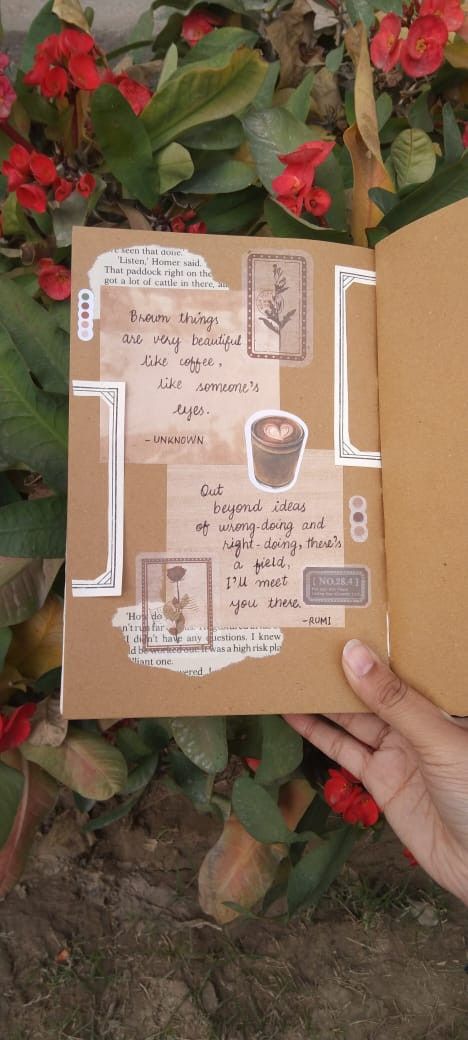 an open book with stickers on it in front of some plants and flowers,