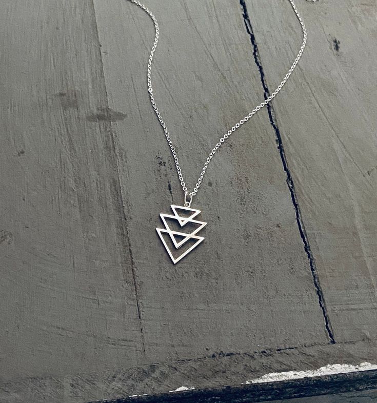 This listing is for a fantastic sterling silver double triangle necklace on a sterling silver fine link chain. This necklace is of incredible quality. DETAILS Pendant: Length: 26mm Width: 16mm Chain: Sterling Silver 1.3mm fine link chain See EXTRAS for longer chain CHECKOUT * Choose Chain Length * Click Add to cart * Choose payment method and finish checkout EXTRAS For a longer chain... https://www.etsy.com/listing/163588132/srerling-silver-chain-add-on Silver Triangle Jewelry For Everyday, Minimalist Sterling Silver Triangle Necklace, Nickel-free Triangle Sterling Silver Jewelry, Minimalist Silver Triangle Necklace, Minimalist Geometric Sterling Silver Necklace, Pyramid-shaped Sterling Silver Jewelry Gifts, Sterling Silver Pyramid Jewelry As Gift, Silver Triangle Necklace For Gift, Sterling Silver Pyramid Jewelry For Gifts